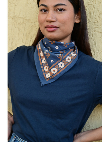 Gros plan sur les motifs floraux fins sur le petit carré bleu marine.