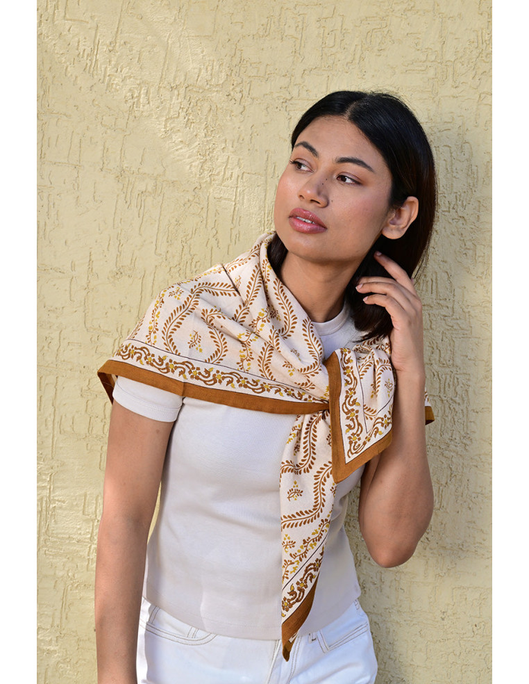 Femme portant le grand foulard Antoinette 100x100 cm noué autour du cou Byzantine