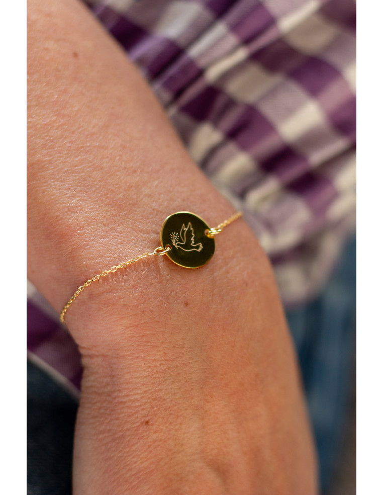 Bracelet fin en plaqué or avec médaillon rond gravé d'une colombe - Comptoir Doré