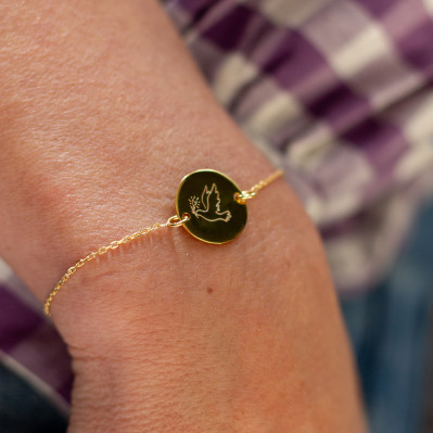 Bracelet fin en plaqué or avec médaillon rond gravé d'une colombe - Comptoir Doré