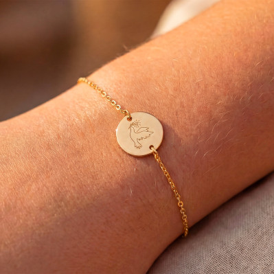 Bracelet fin en plaqué or avec médaillon rond gravé d'une colombe - Comptoir Doré
